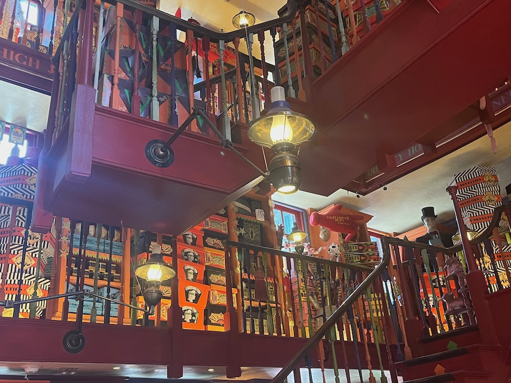 In diagon alley at universal studios florida, weasleys wizard wheezes is piled high with real and pretend magic items.