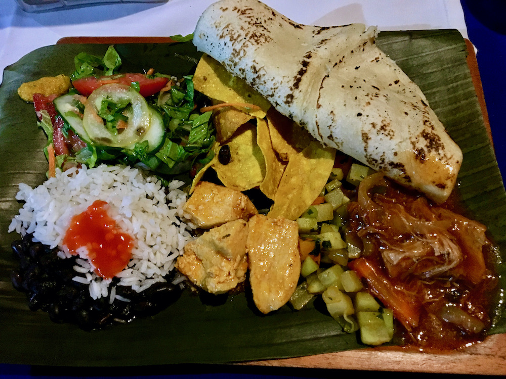 a farmhouse dinner at casa vida near la fortuna includes beef in salsa, stewed chicken, chayote, rice and beans and homemade tortillas.