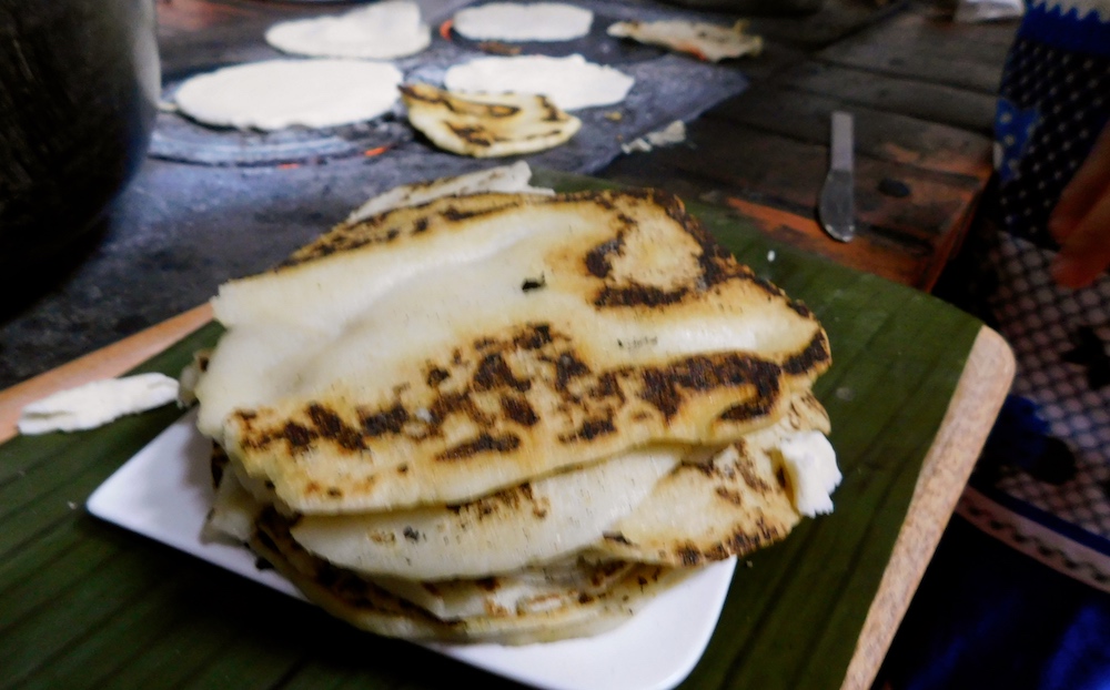 slightly charred, hand-trolled tortillas are part of a farm dnner near arenal, costa rica