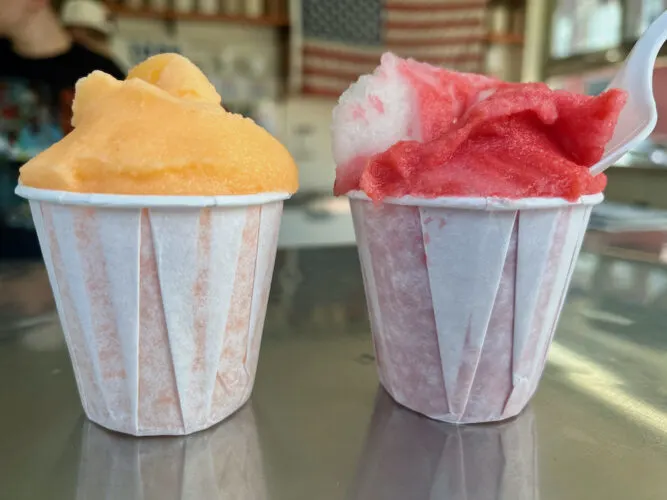 peach and cherry-vanilla italina ices sit on the counter at the lemon ice king of coron