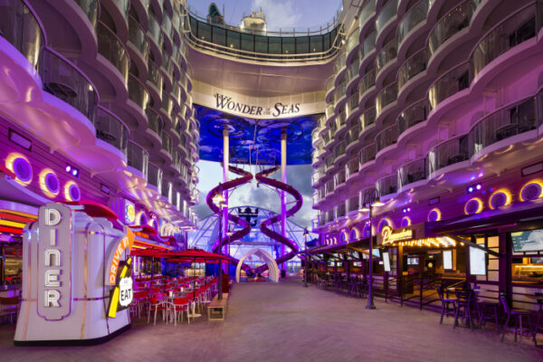 The soaring boardwalk atrium at the heart of royal caribbean's new cruise ship, wonder of the seas.