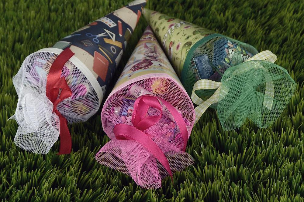 Schultütes are a german tradition for the first day of school and something you can easily make at home with tissue and wrapping paper, oaktag and small school supplies and candy to fill them with.