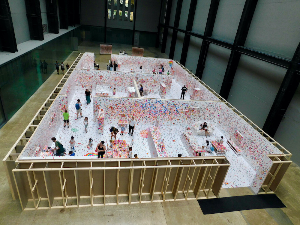 Families cover a maze of rooms with dot stickers at th tate modern in london