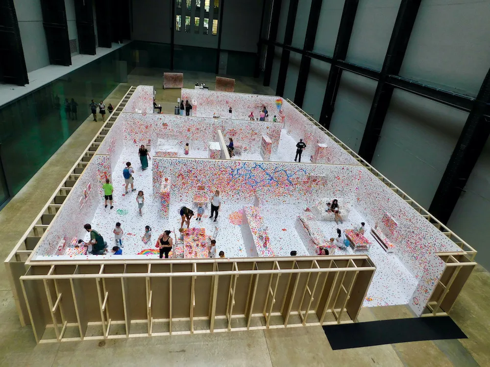families cover a maze of rooms with dot stickers at th tate modern in london