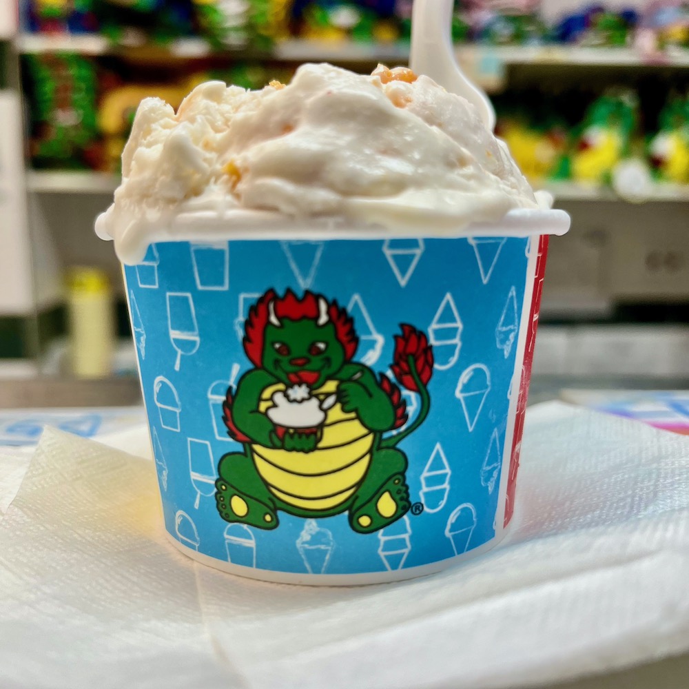 Almond cookie ice cream from china tow ice cream factory is full of almost flavor and bits of cookies. One scoop comes in the cup with the store's ice-cream-eating dragon