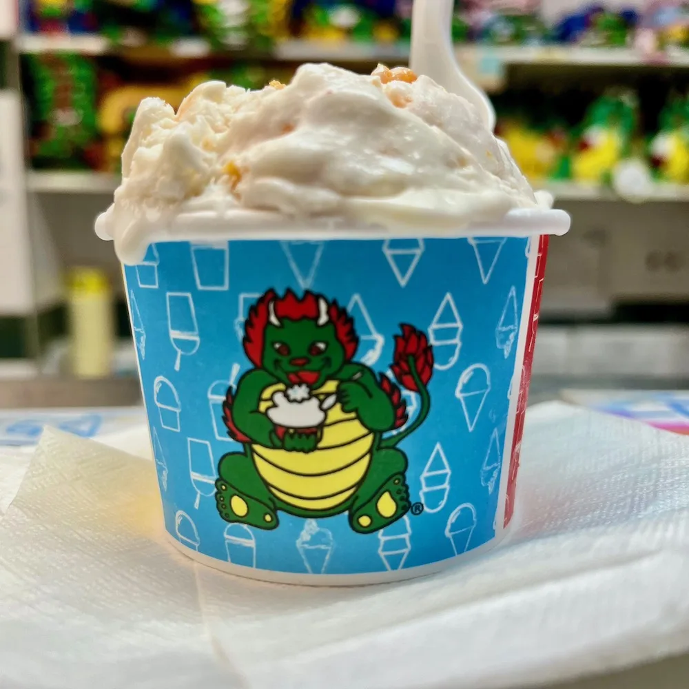 almond cookie ice cream from china tow ice cream factory is full of almost flavor and bits of cookies. one scoop comes in the cup with the store's ice-cream-eating dragon