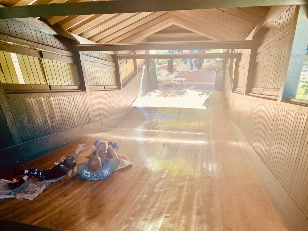 A big wooden slide hidden inside a barn at the smith memorial playground inn fairmont park.