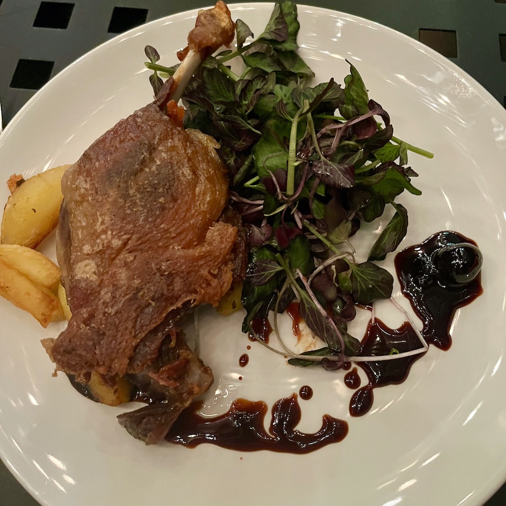 crispy duck breast with potatoes and salad at the royal boucherie in philly's historic district.