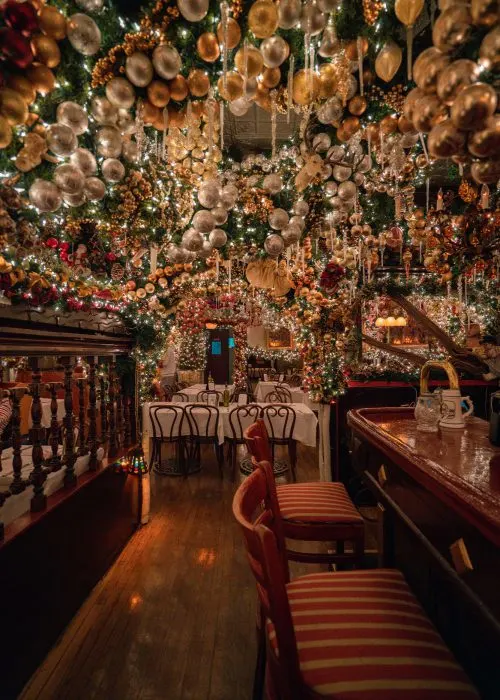 rolf's german restaurant in nyc explodes with lights, icicles, greens and other decorations at christmas time.