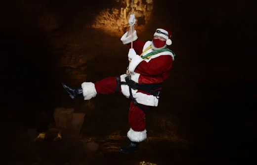 Discover The Best Local Christmas Activities Across The U.s. santa arrives with a rope and carabiners at natural bridge caverns in texas.