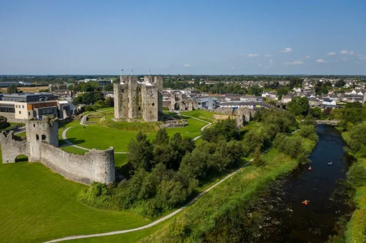 trim castle is a tall fortress that sits betwee the boyne river and a former medieval town.