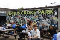 teenages take a breal from watching the irish football action at croke park in ireland.