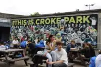 teenages take a breal from watching the irish football action at croke park in ireland.