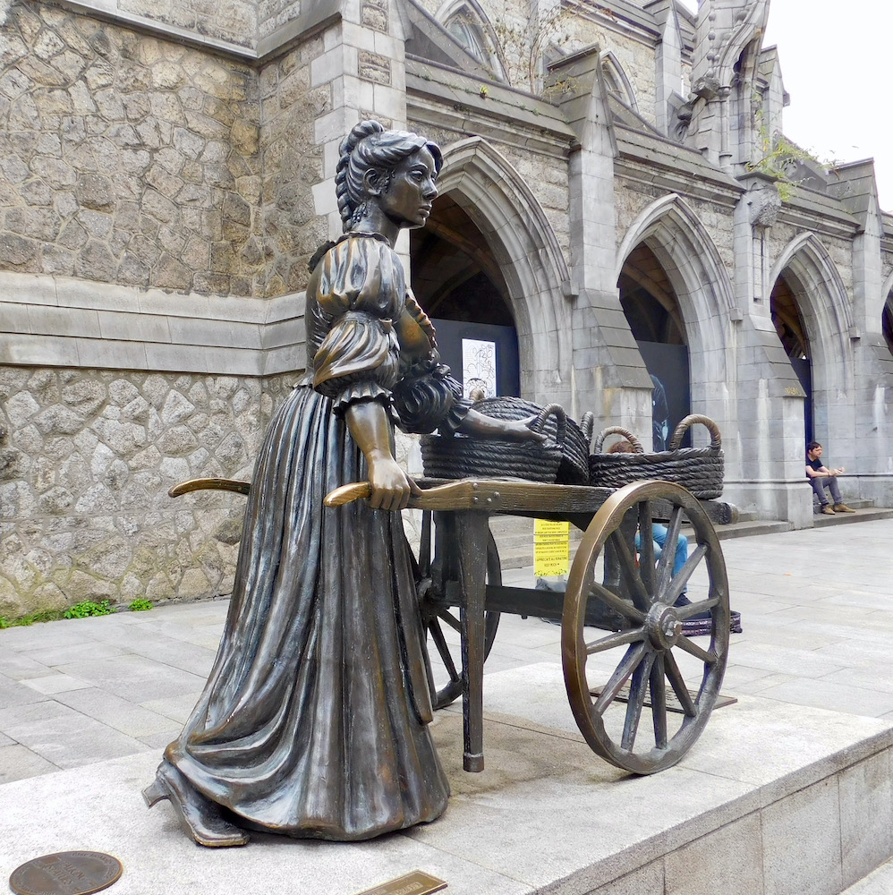 a statue of molly malone and her wheel barrow in dublin, or the "tart with the cart" as the dubliners like to call her.