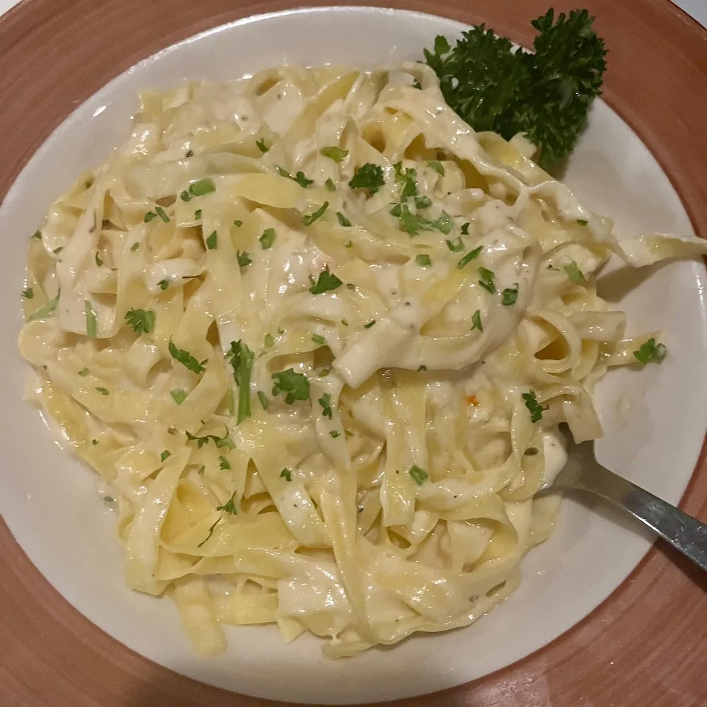 dishes like this creamy fettuccini alfredo make jimmy's 21 a popular lake placid restaurant for families.