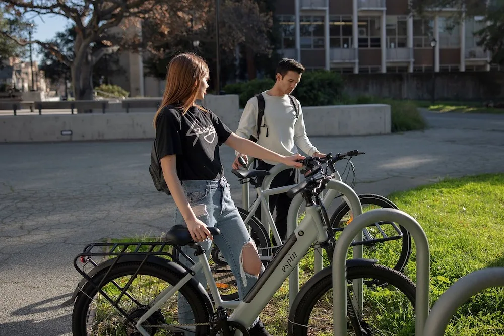 college students park e-bikes on campus before heading to class.