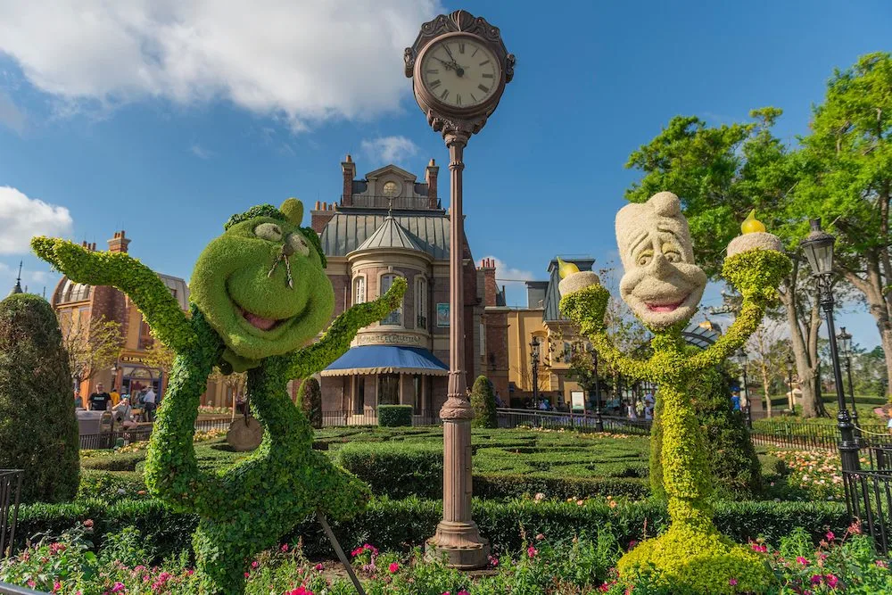 lumiere and cogsworth are two of the many disney animated characters recreated in topiary for the epcot international flower & garden festival