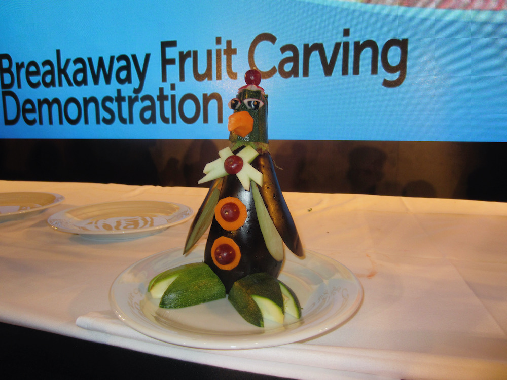 a penguin makde from eggplant, zucchini, carrots andcherry tomatoes is part of fruit carving lesson on the breakaway.