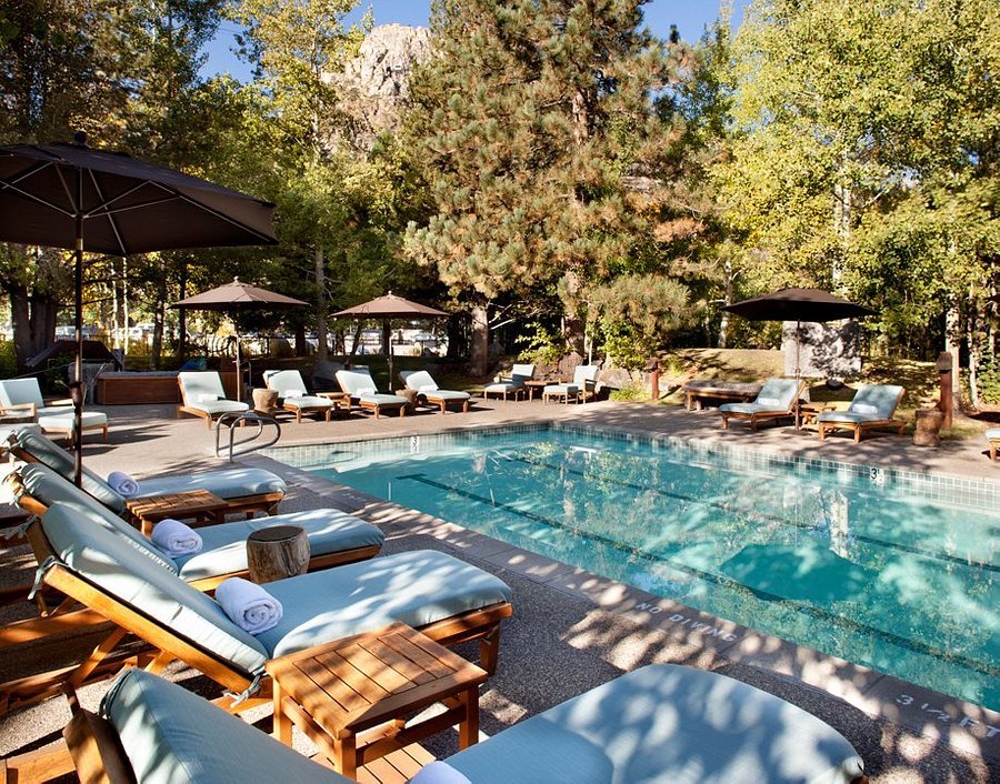 the outdoor pool at the plumpjack inn has comfortable lounge chairs, plus trees and umbrellas for shade.