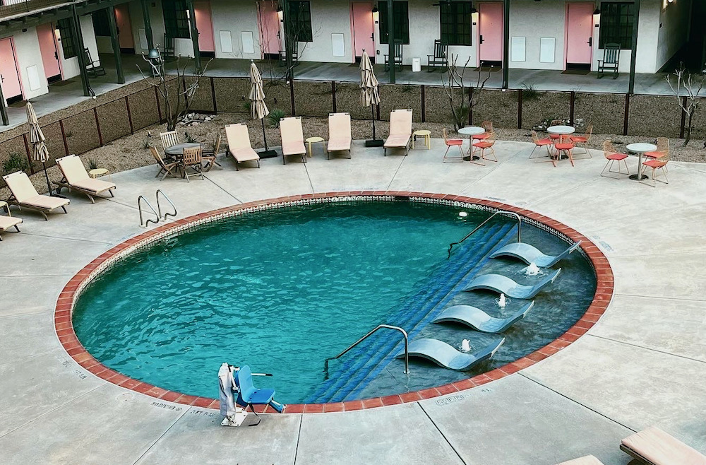 the pool at the texican court in irving, texas is round and covered in mexican tiles for a hacienda feel.