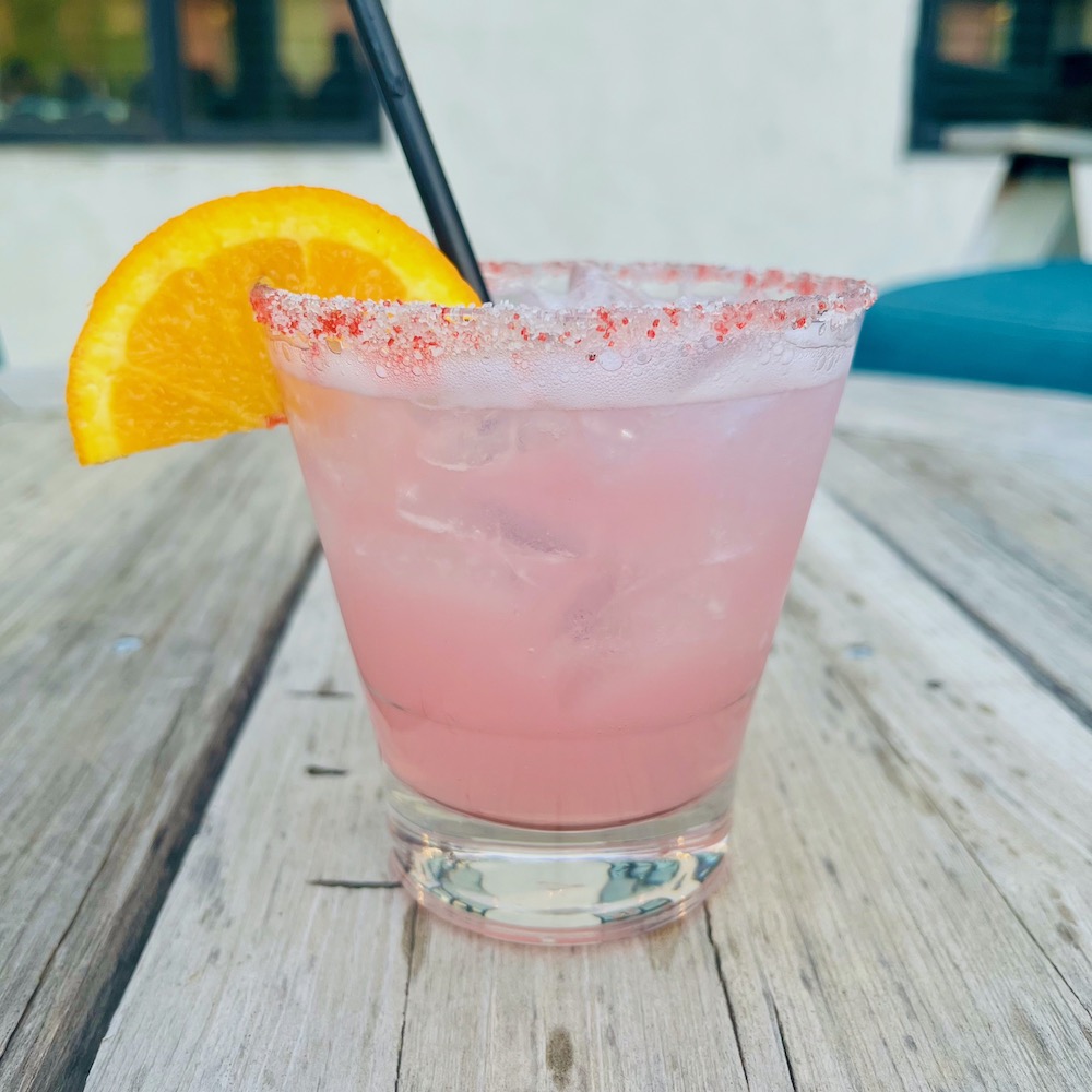 A bright pink cactus-pear margarita with salt and chiles on the rim of the glass from the texican court hotel