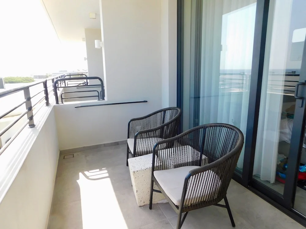 two chairs and a table on a balcony at mangrove beach corendon resort