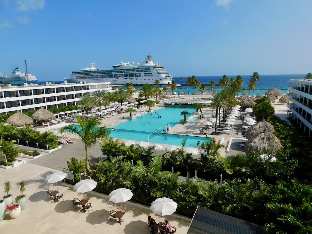 a cruise sits in dock near the mangrove beach corendon resort in curacao.