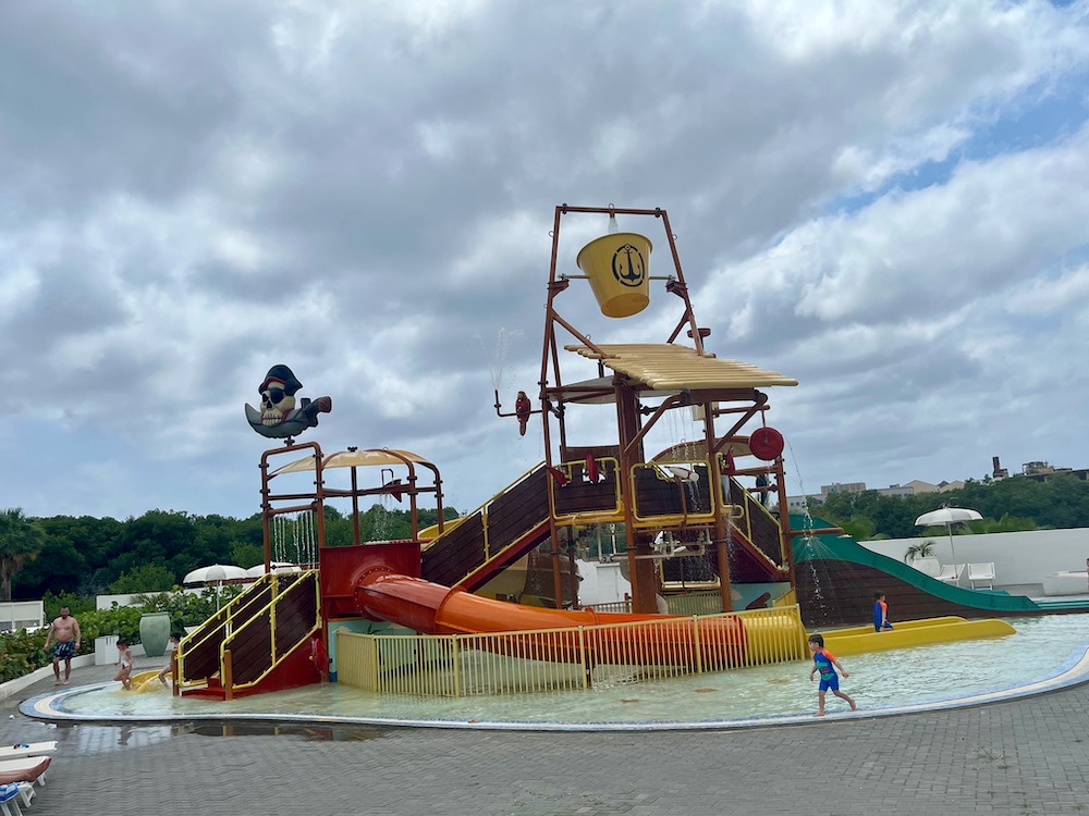 Hilton's mangrove beach all-inclusive resort in curacao has a water-play area with a splash bucket for kids.