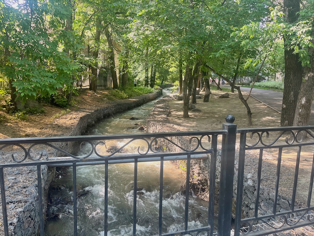 This shaded riverside walk in almaty is full of walkers, joggers and commuters on weekday mornings.