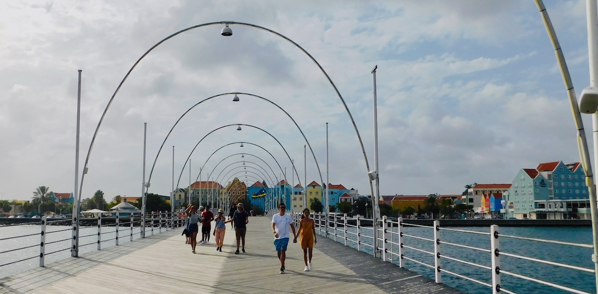 the queen emma swing bridge connects punda and otrabanda, willemstad's colorful waterfront neighborhoods.