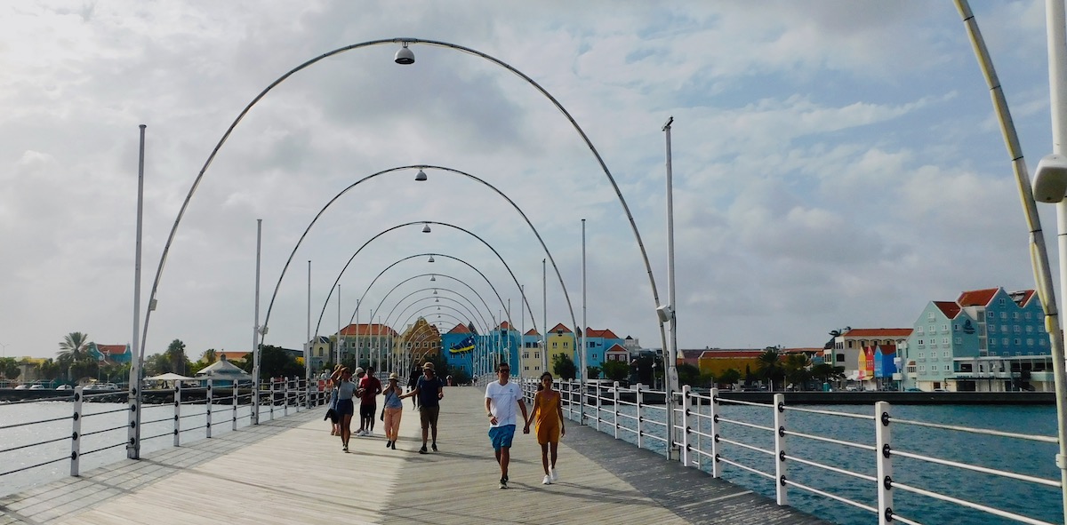 The queen emma swing bridge connects punda and otrabanda, willemstad's colorful waterfront neighborhoods.