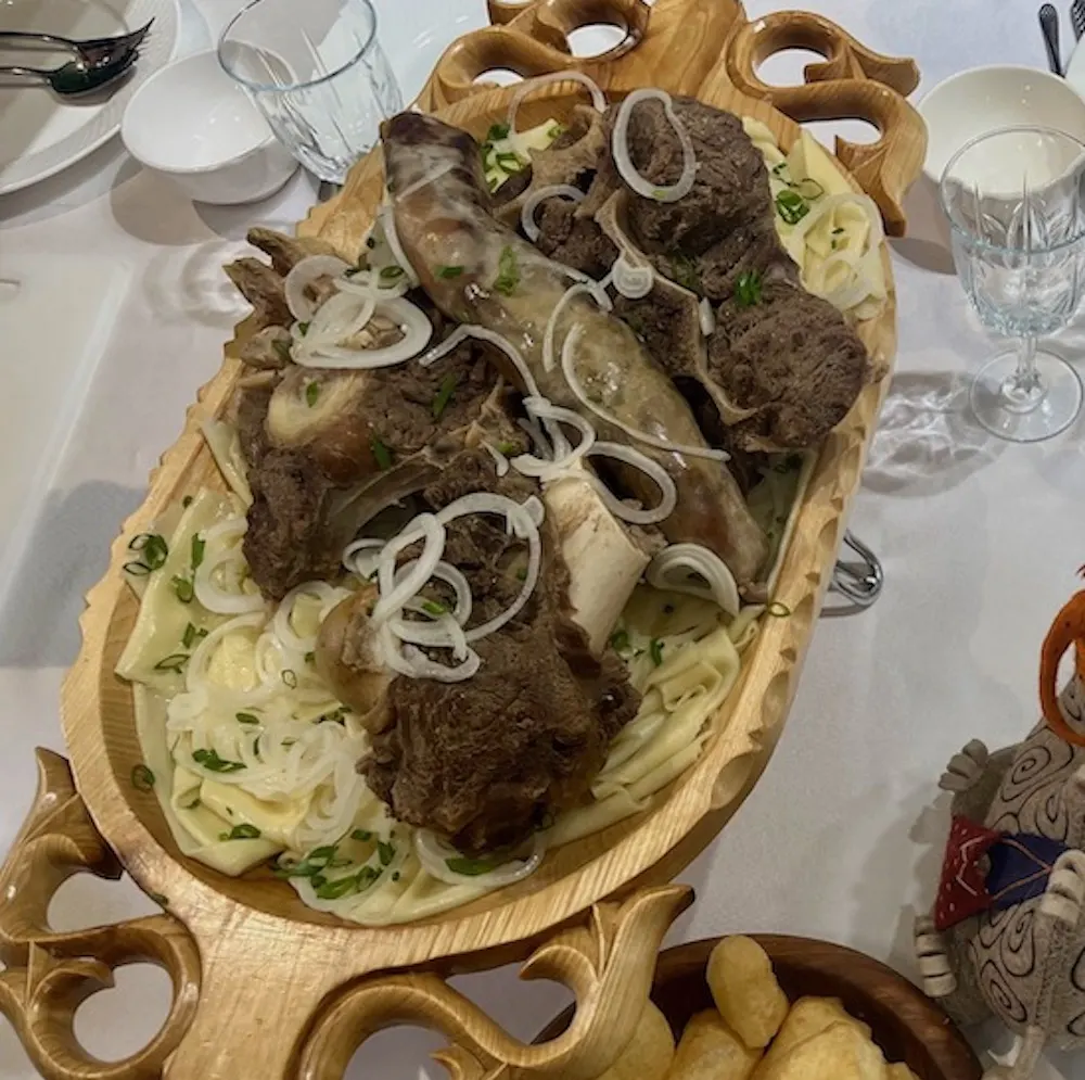 a platter of stewed horsemeat and handmade noodles, a traditional kazak dish that is suprisingly good.