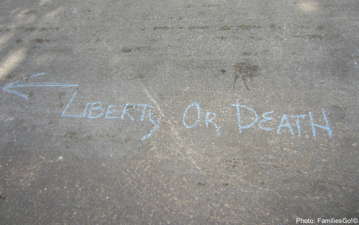 "liberty or death" written in chalk on the pavement in williamsburg, va