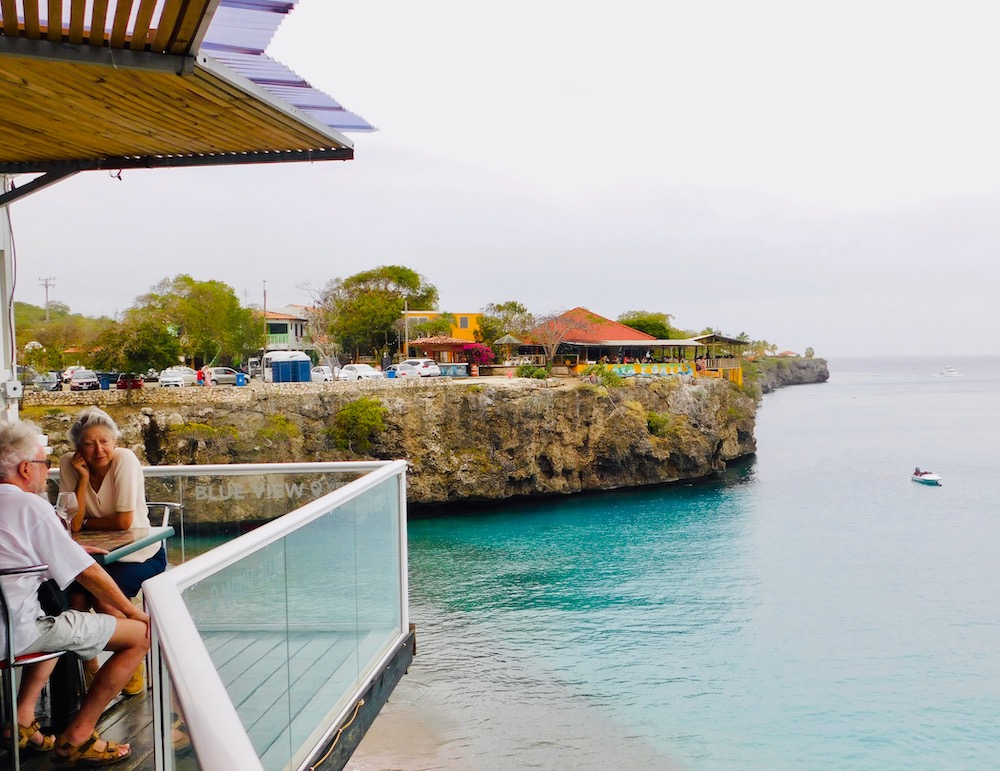 One of the best things to do in curacao is to have lunch near the playa forti cliff, where you can watch people jump from on high into the water.