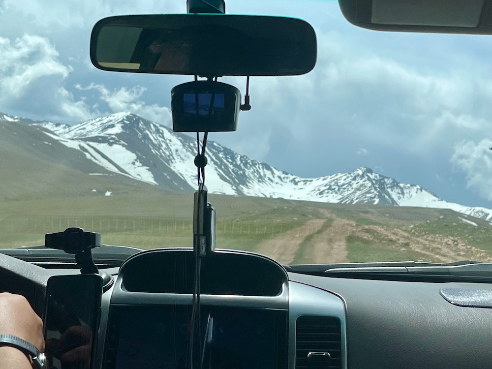 the ile-alatau plateau's roads can disappear as seem over the dashboard of a car. with a guide and driver, exploring the area is a fun thing to do in kazakhstan with kids.