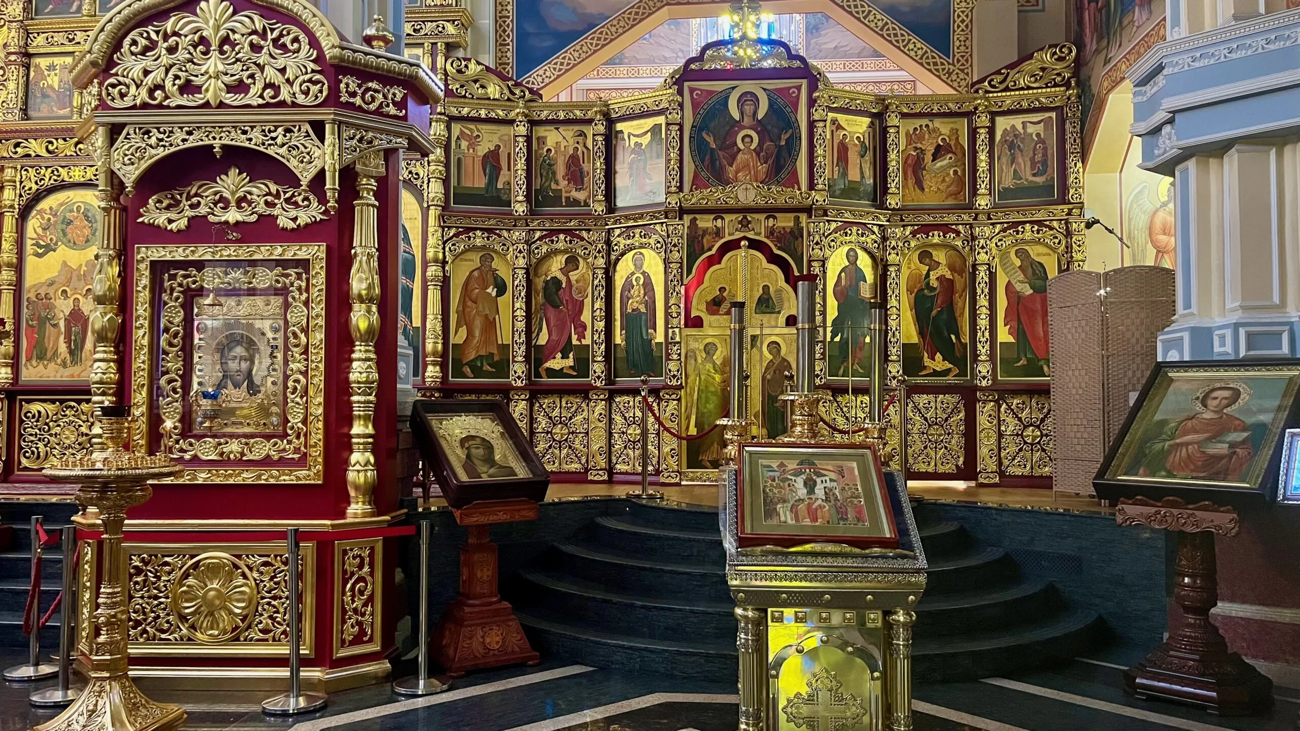 the interior of zenkov cathedral is full of iconography in deep colors with gilded framework