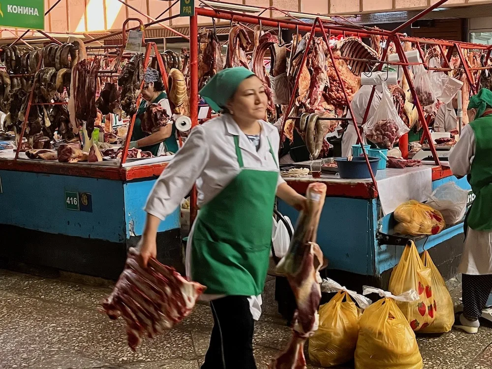 the butcher section of almaty's central bazaar is busy and well-stocked