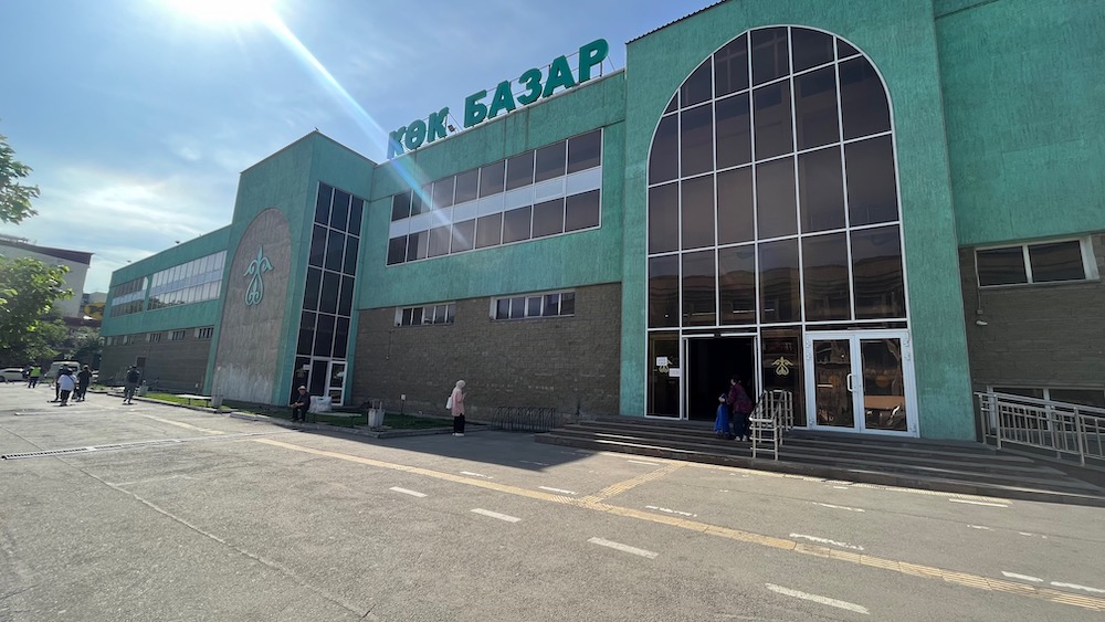 the green exterior of the green bazaar with cyrilic letters in almaty
