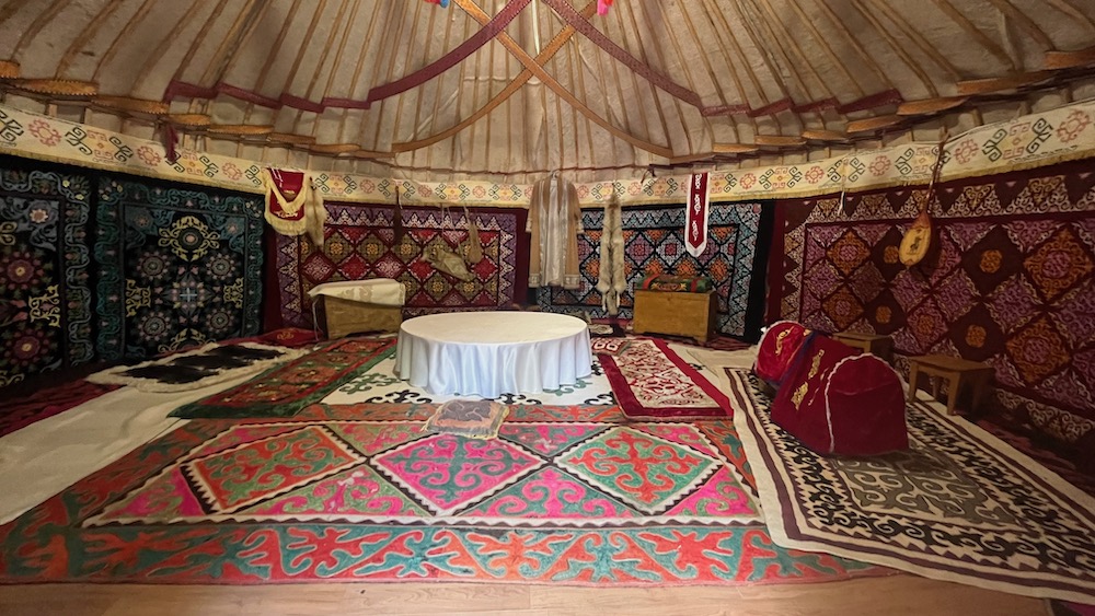 A yurt typical of kazakhstan's nomadic tribes, filled with rugs and pelts.