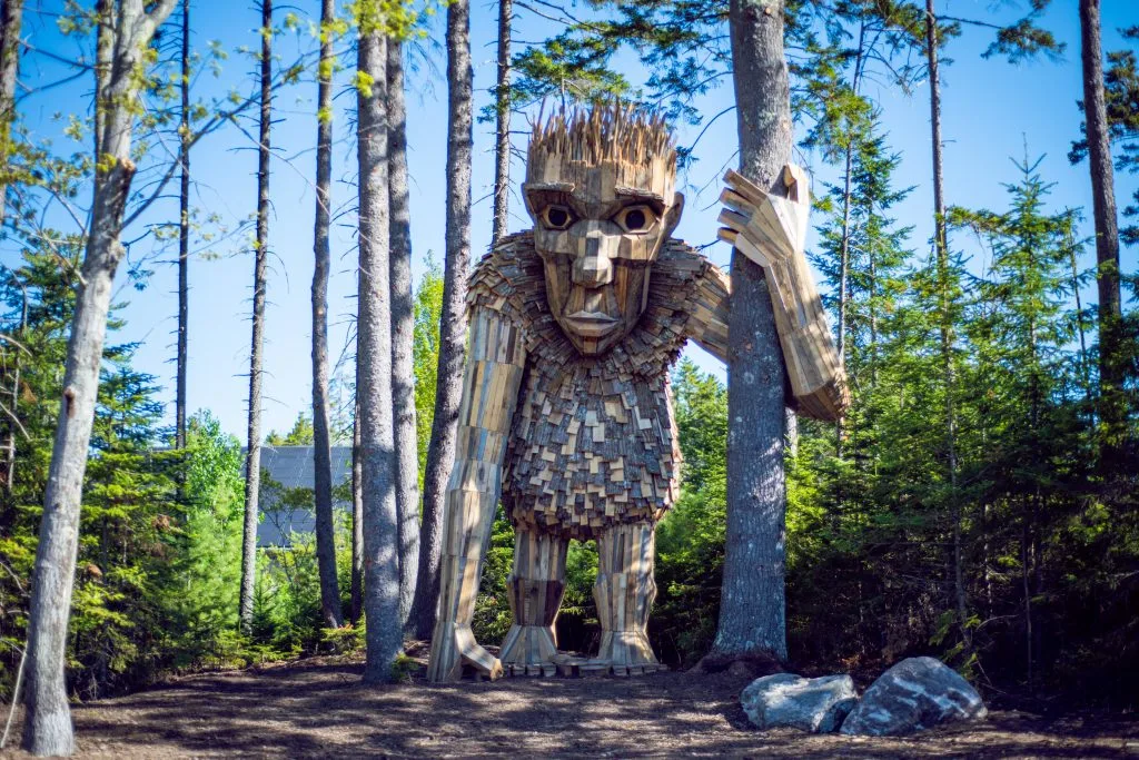 8 East-Coast Towns For Phenomenal Fall Foliage &Amp; Family Fun giant wooden trolls hide in the fall foliag and flowers at the coastal main botanical garden