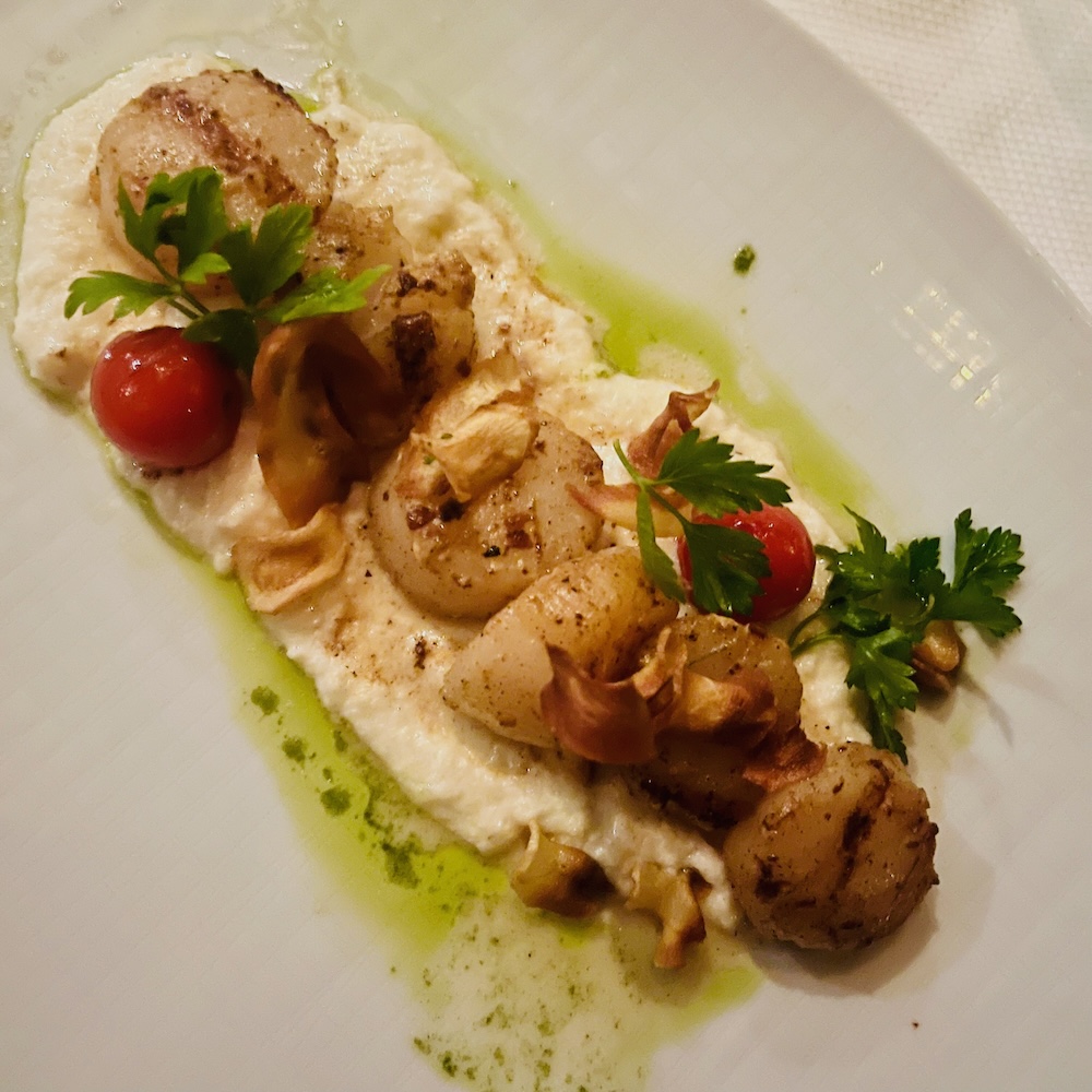 Scallops on a bed of pureed root vegetables is a seafood option at the pinnacle grill on the oosterdam.