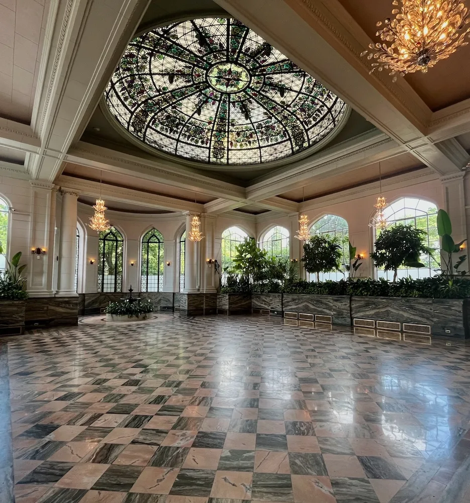 casa loma's conservatory has a stained-glass dome, marble floor and picture windows.