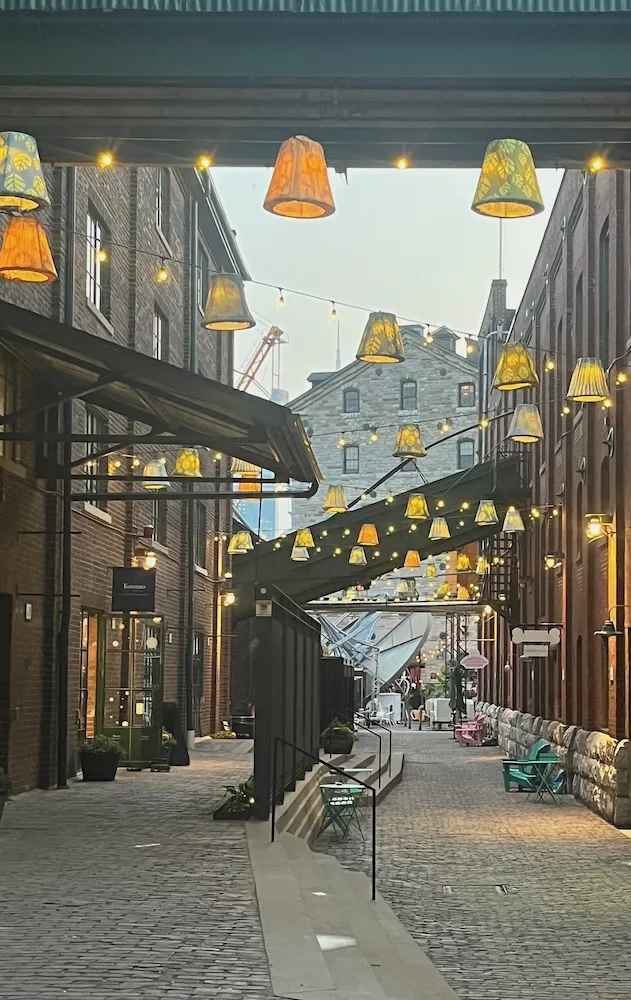 toronto's distillery district is romantic when lit up at night perfect place to explore on a couples weekend.