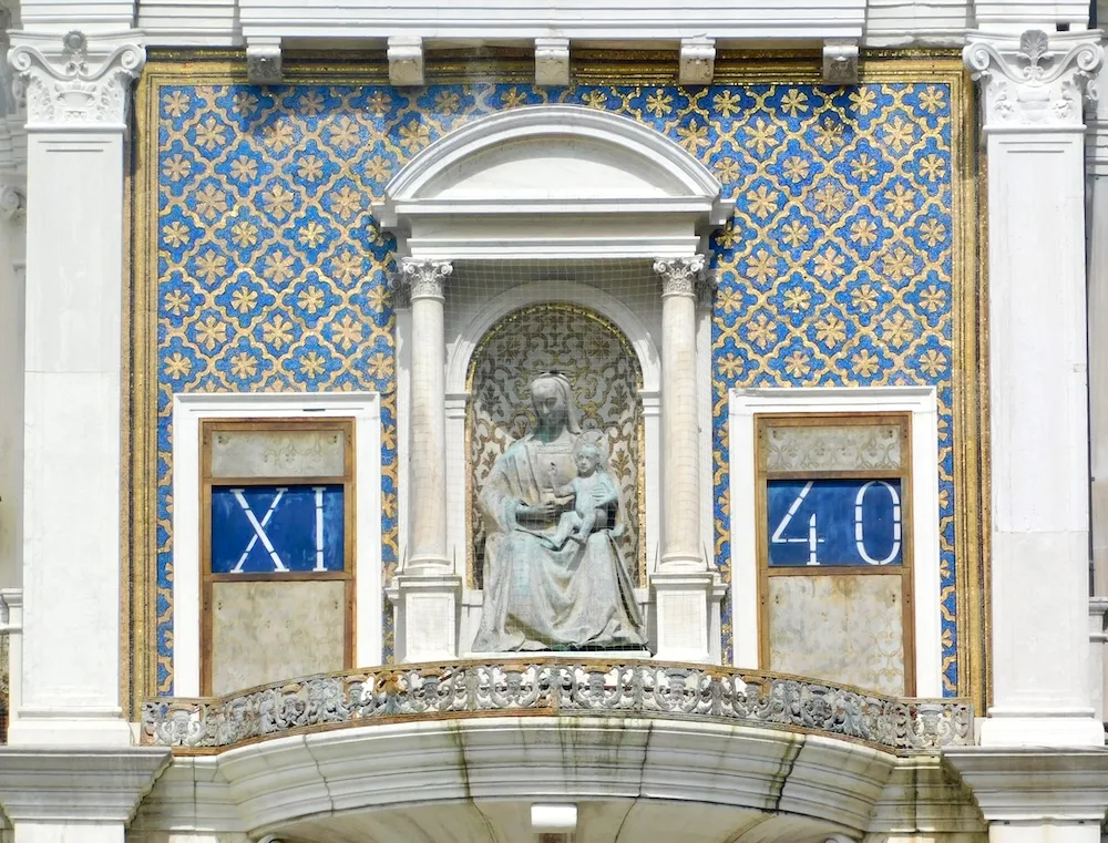 st. mark's square has an early digital clock with hours in roman numerals and minutes in arabic numbers.