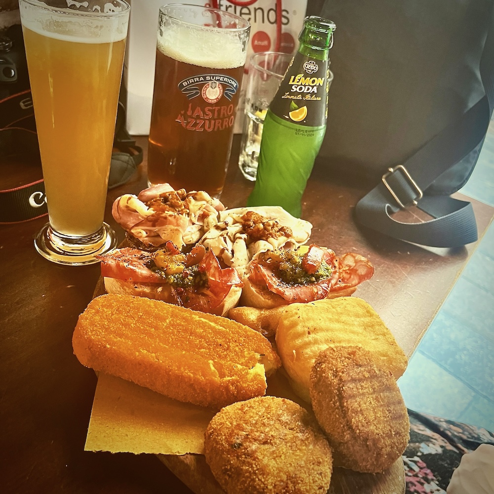 A place ot venetian cicchetti including little sandwiches and croquettes, accompanied by beer and lemon soda.