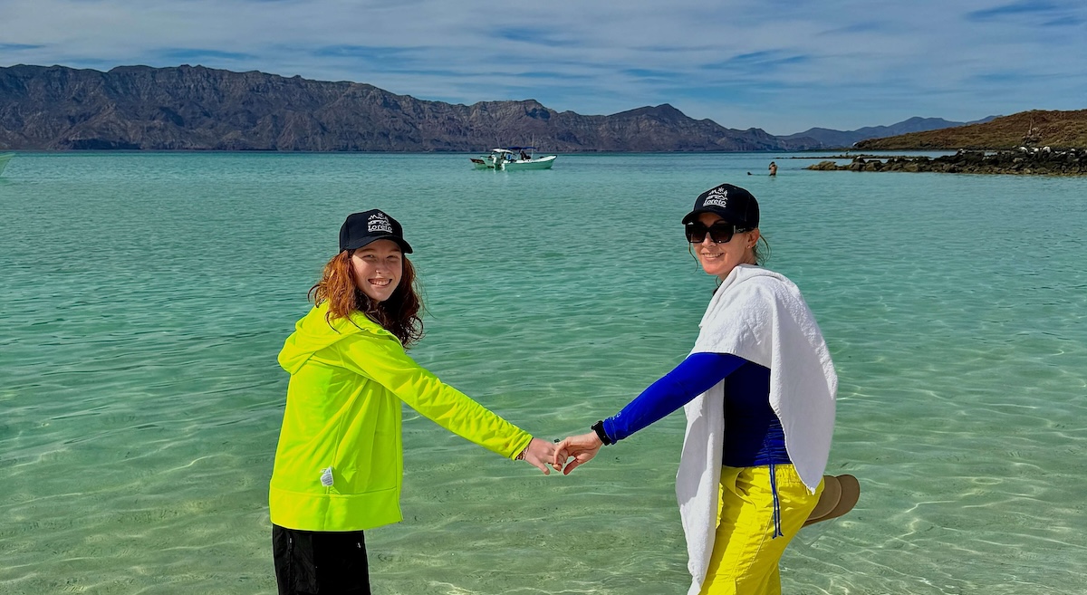 Loreto, Mexico: 10 Adventurous Things To Do & See With Kids: A mom and daughter head into the clear water off the shore of Coronadao Island near Loreta, Baja Sur California