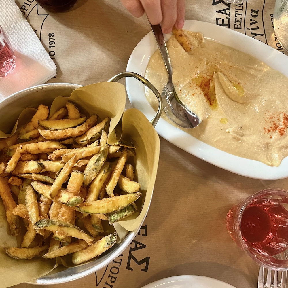 Crispy zucchini fries and a bowl of hummus at achilles vergina in exarchia
