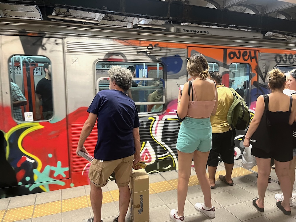 a subway train in athens is decorated with graffiti, but the metro is a safe, fast and cheap way to get around the city with teens.