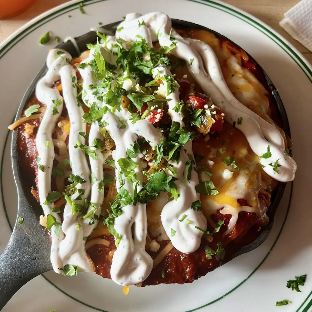 cas-iron enchiladas at rochester's dorado have layers of roast pork, corn tortilla, cheese, beans and earthy red salsa.