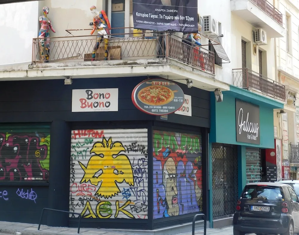 murals and funky stores are part of the streetscape in the exarchia neighborhood of athens.